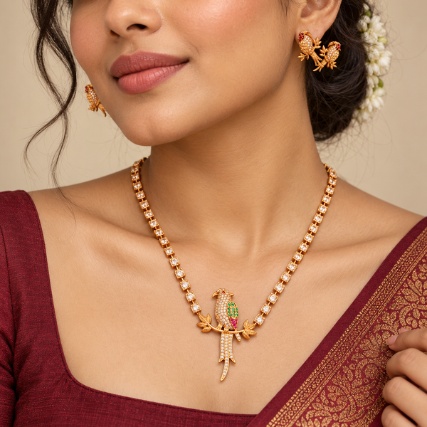 Model wearing gold plated parrot necklace set with maroon silk saree