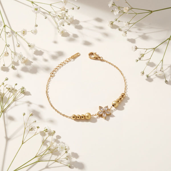 Gold Plated Beaded Stretch Bracelet with White Stone Floral Star Charm
