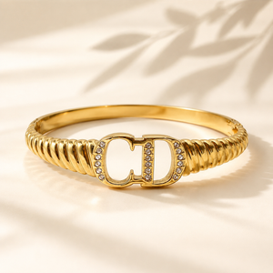 Gold CD Logo Initials Ribbed Twisted Band Oval Kada for Women | Monogram Designer Stainless Steel Ladies Bangle | Luxury Brand Festive Jewellery