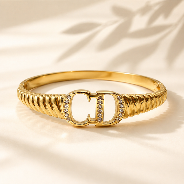 Gold CD Logo Initials Ribbed Twisted Band Oval Kada for Women | Monogram Designer Stainless Steel Ladies Bangle | Luxury Brand Festive Jewellery - House of Viya